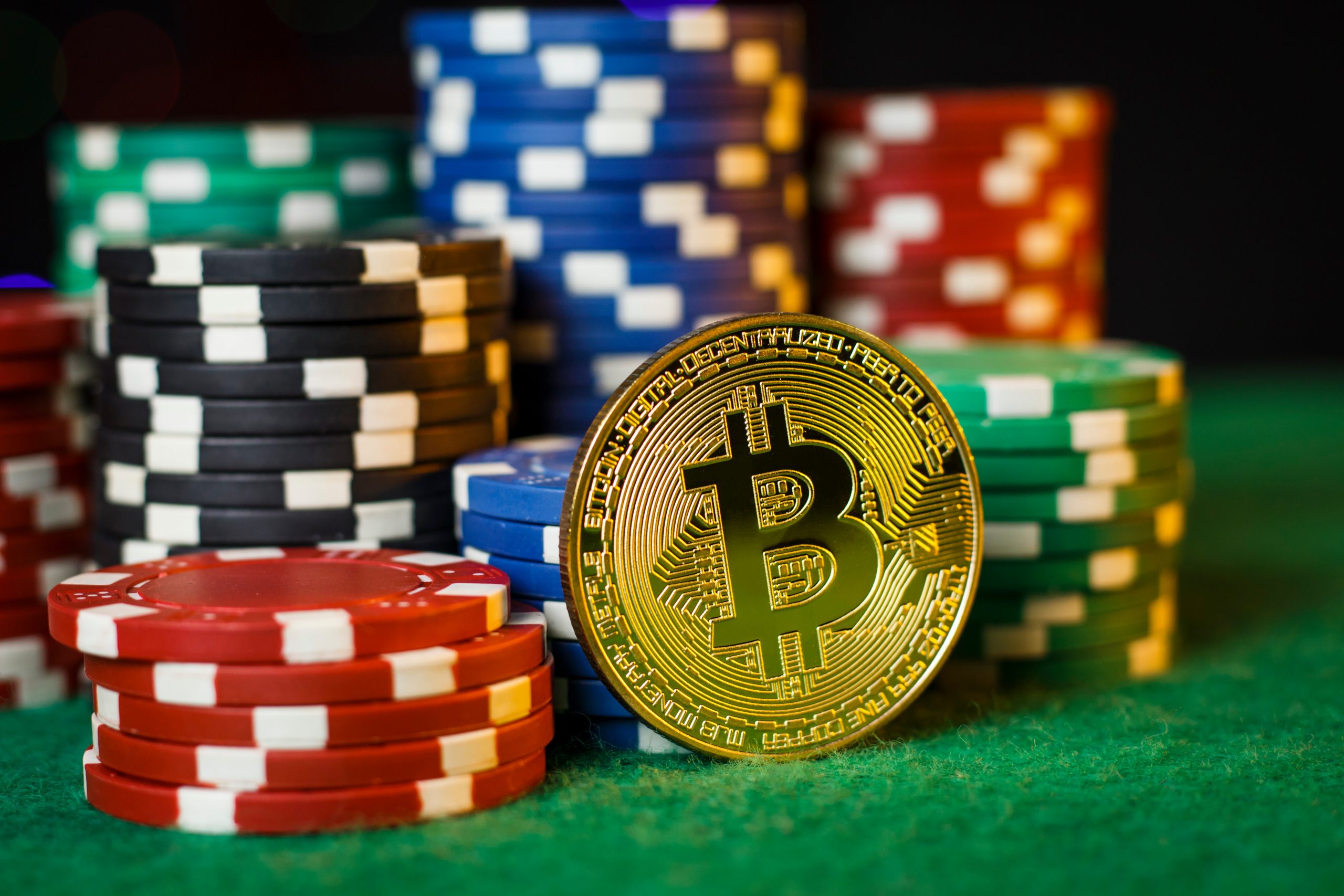 Bitcoin gold coin on the poker table with chips Casino